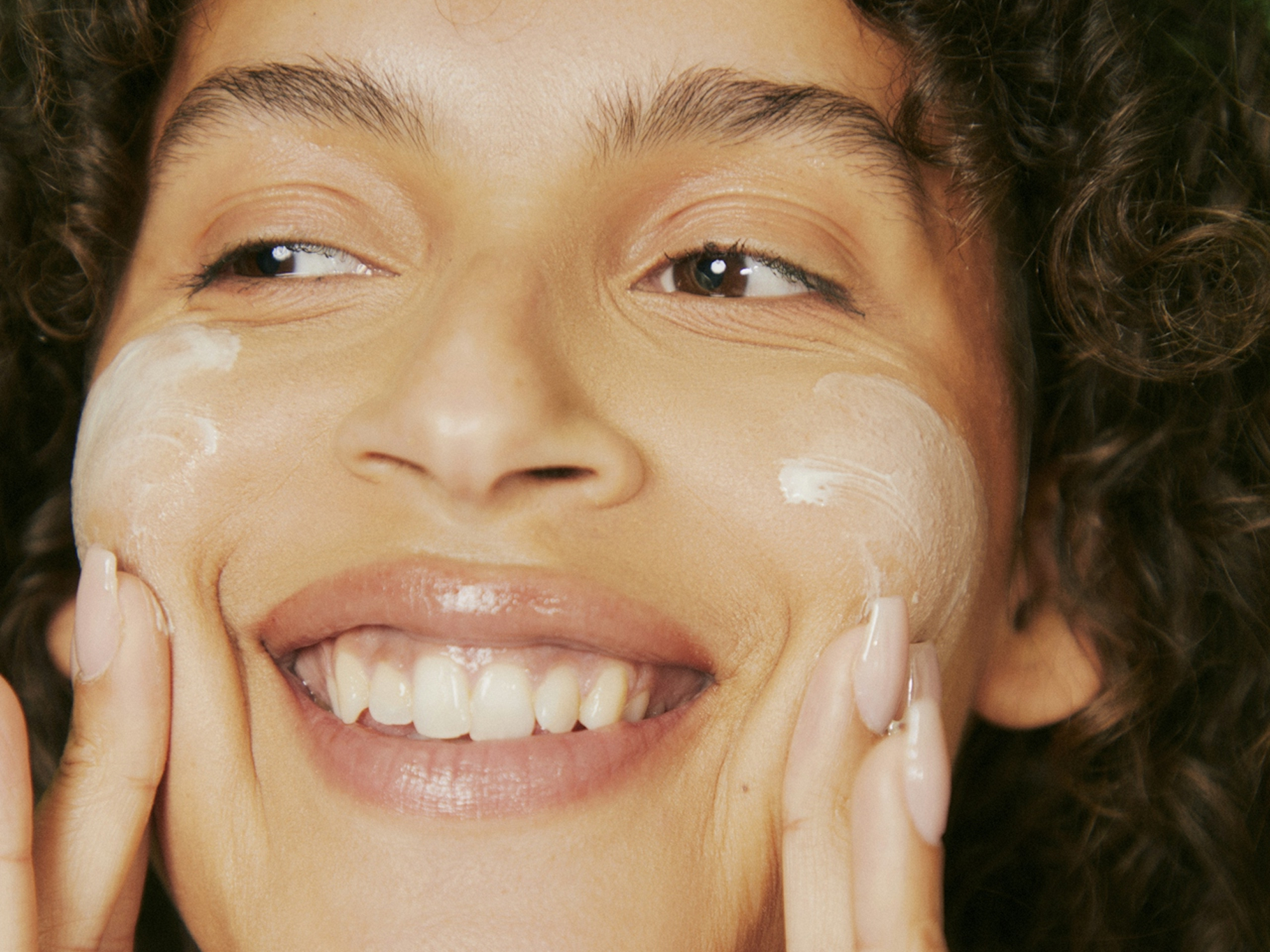 Woman applying skincare in beauty salon for luxury experience.